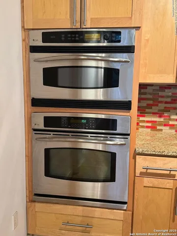 a stove top oven sitting inside of a kitchen