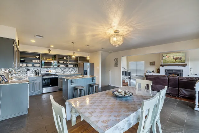a view of a dining room kitchen and a chandelier