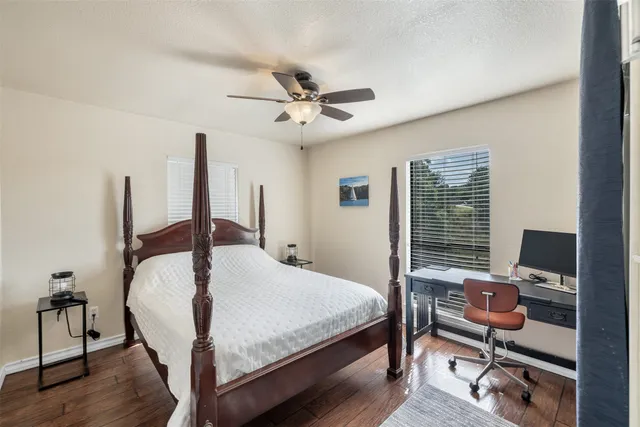 a bedroom with a bed window and a desk