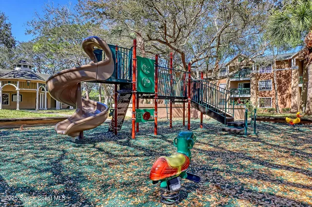 a dining room with wooden floor a chandelier a wooden table and chairs