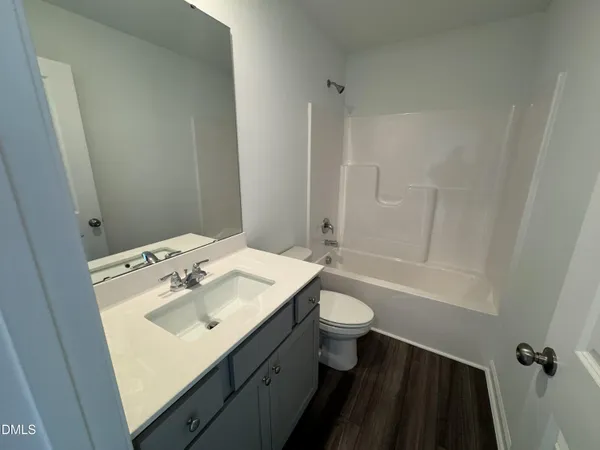 a bathroom with a sink toilet tub and shower