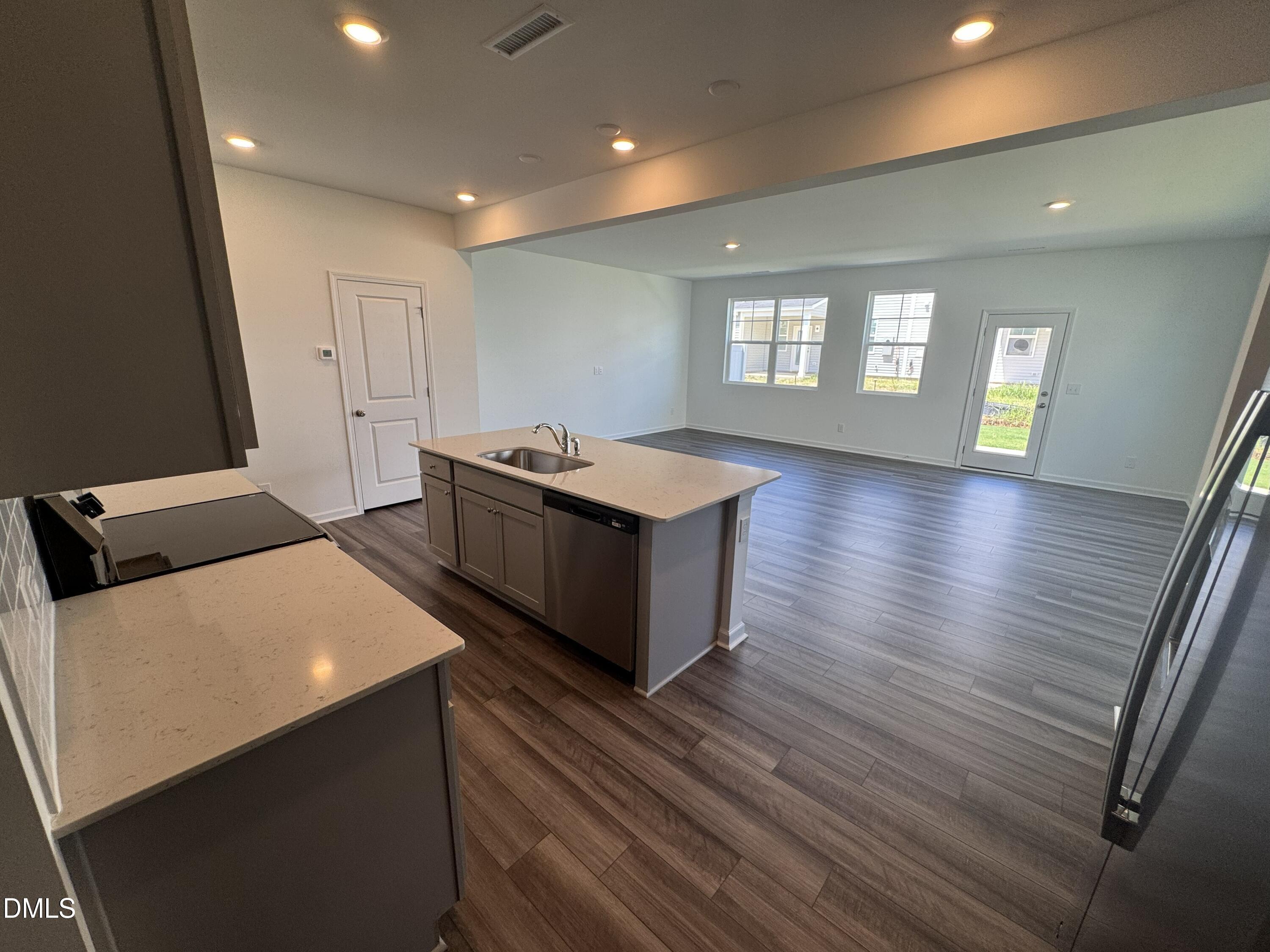 300 Thompson Overlook Way Smithfield, NC 27577 - Photo 3 of 41 a kitchen with stainless steel appliances granite countertop a stove and a refrigerator
