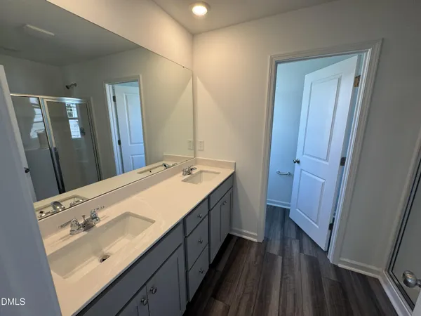 a bathroom with a double vanity sink and mirror