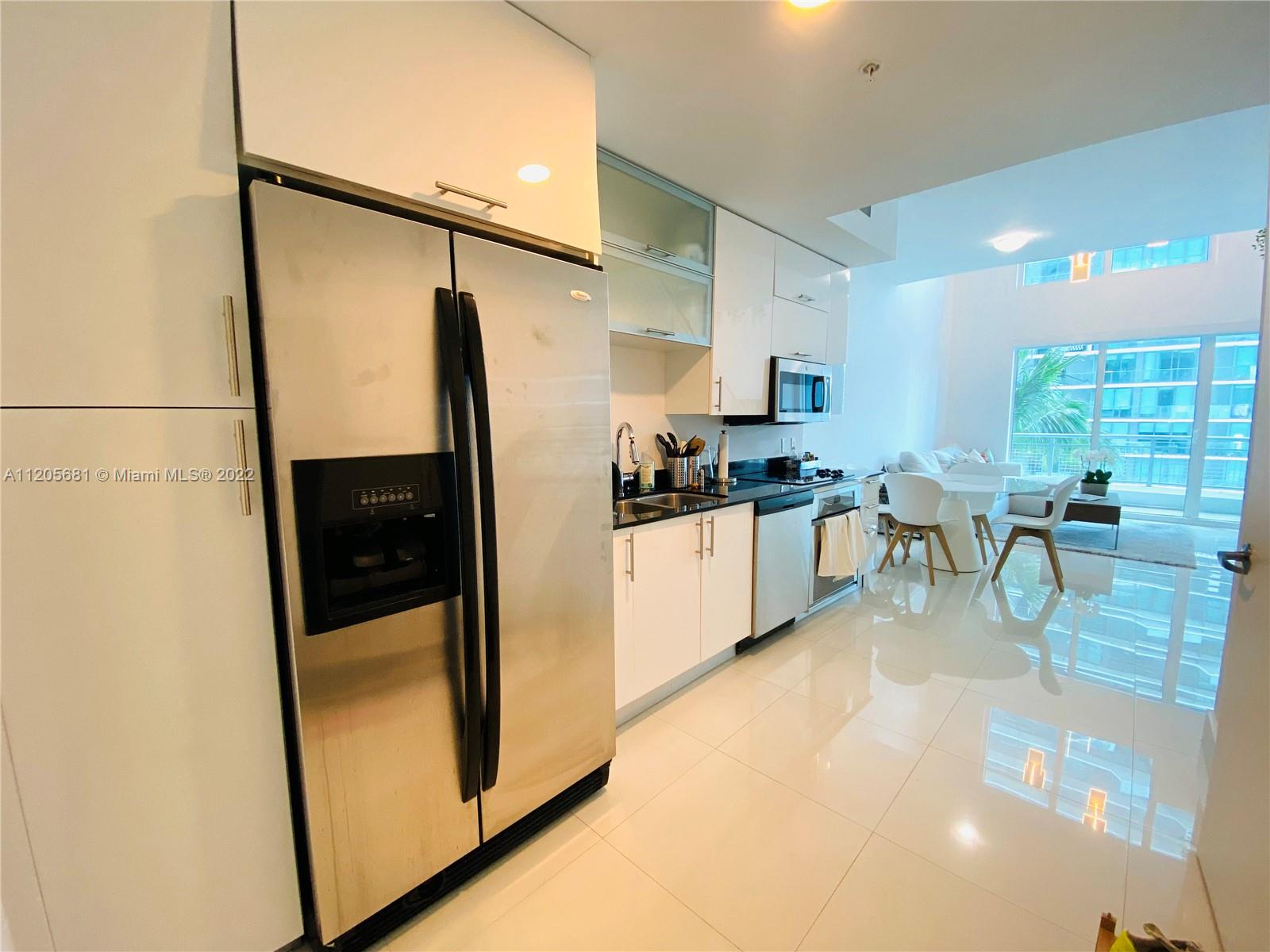 60 Southwest 13th Street, Unit 1412 Miami, FL 33130 - Photo 2 of 39 a kitchen with stainless steel appliances a refrigerator and a sink