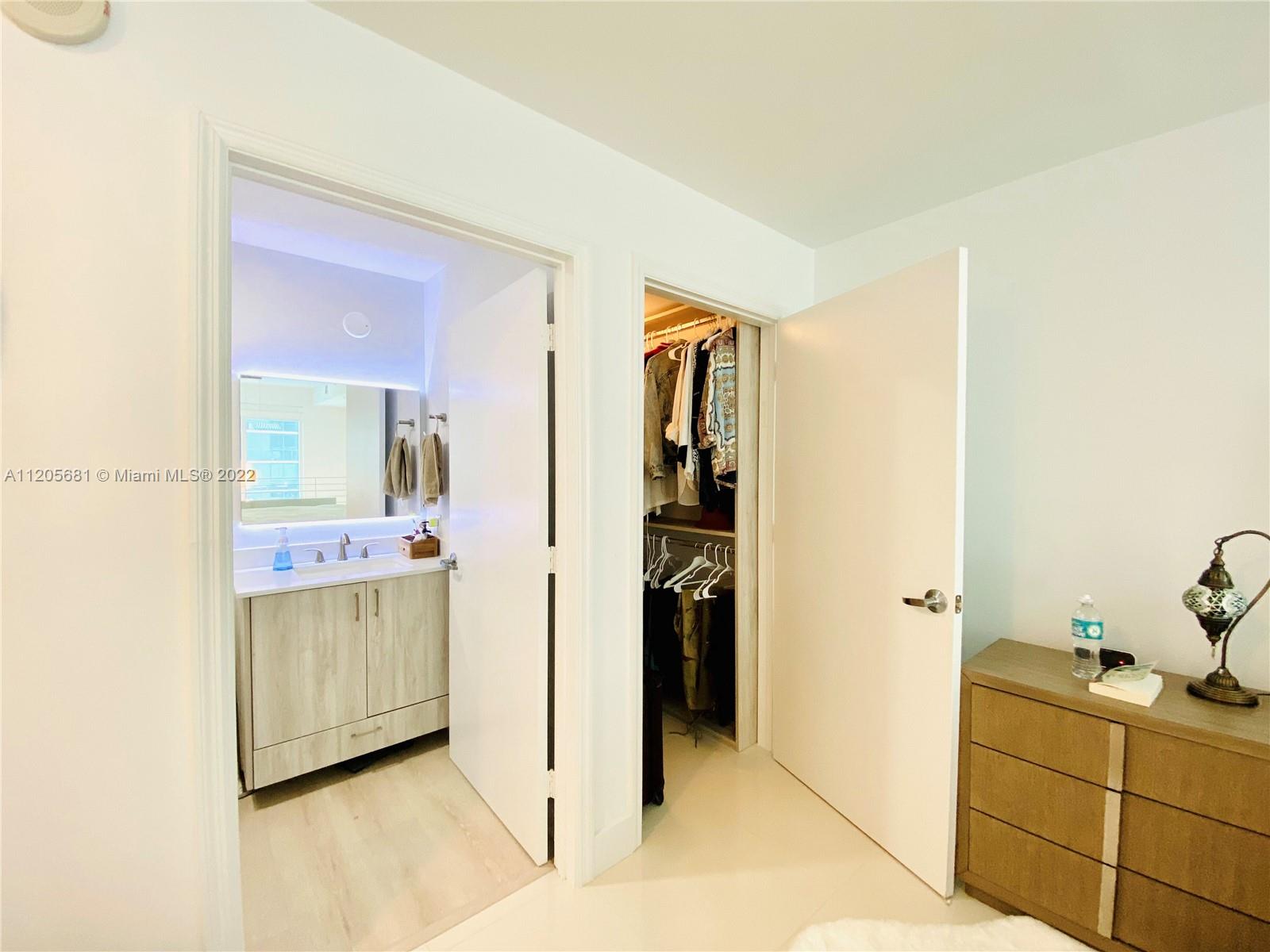 60 Southwest 13th Street, Unit 1412 Miami, FL 33130 - Photo 25 of 39 a bathroom with a tub sink and mirror