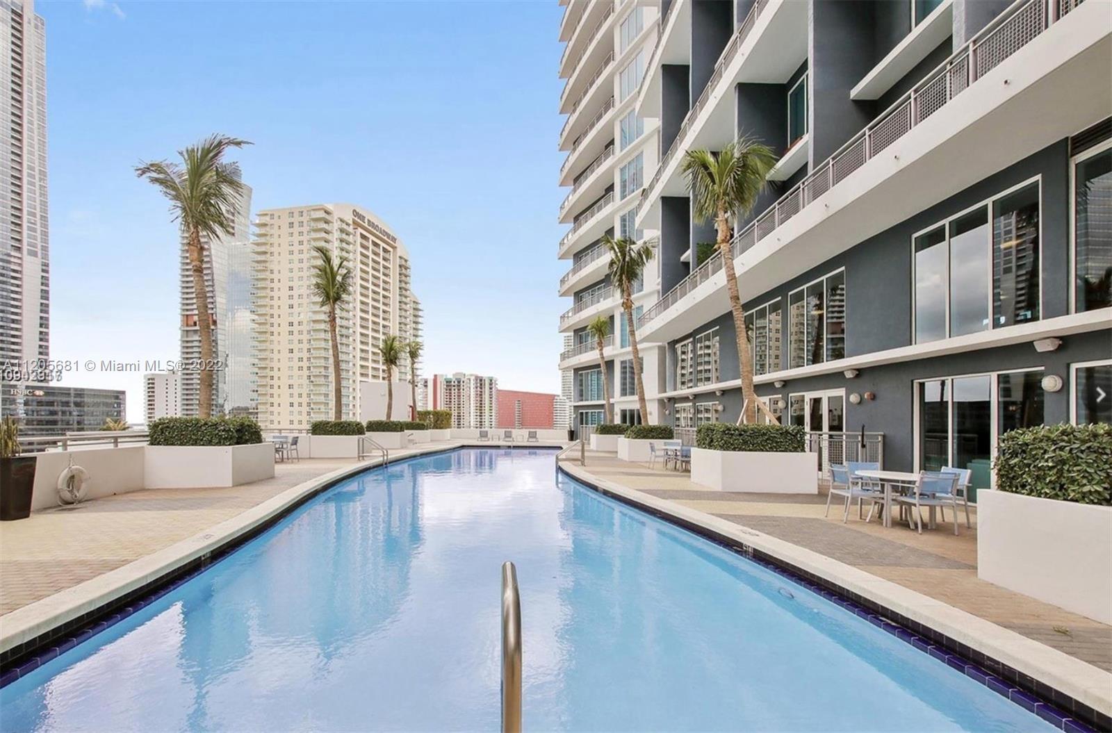 60 Southwest 13th Street, Unit 1412 Miami, FL 33130 - Photo 32 of 39 a view of a swimming pool with outdoor seating