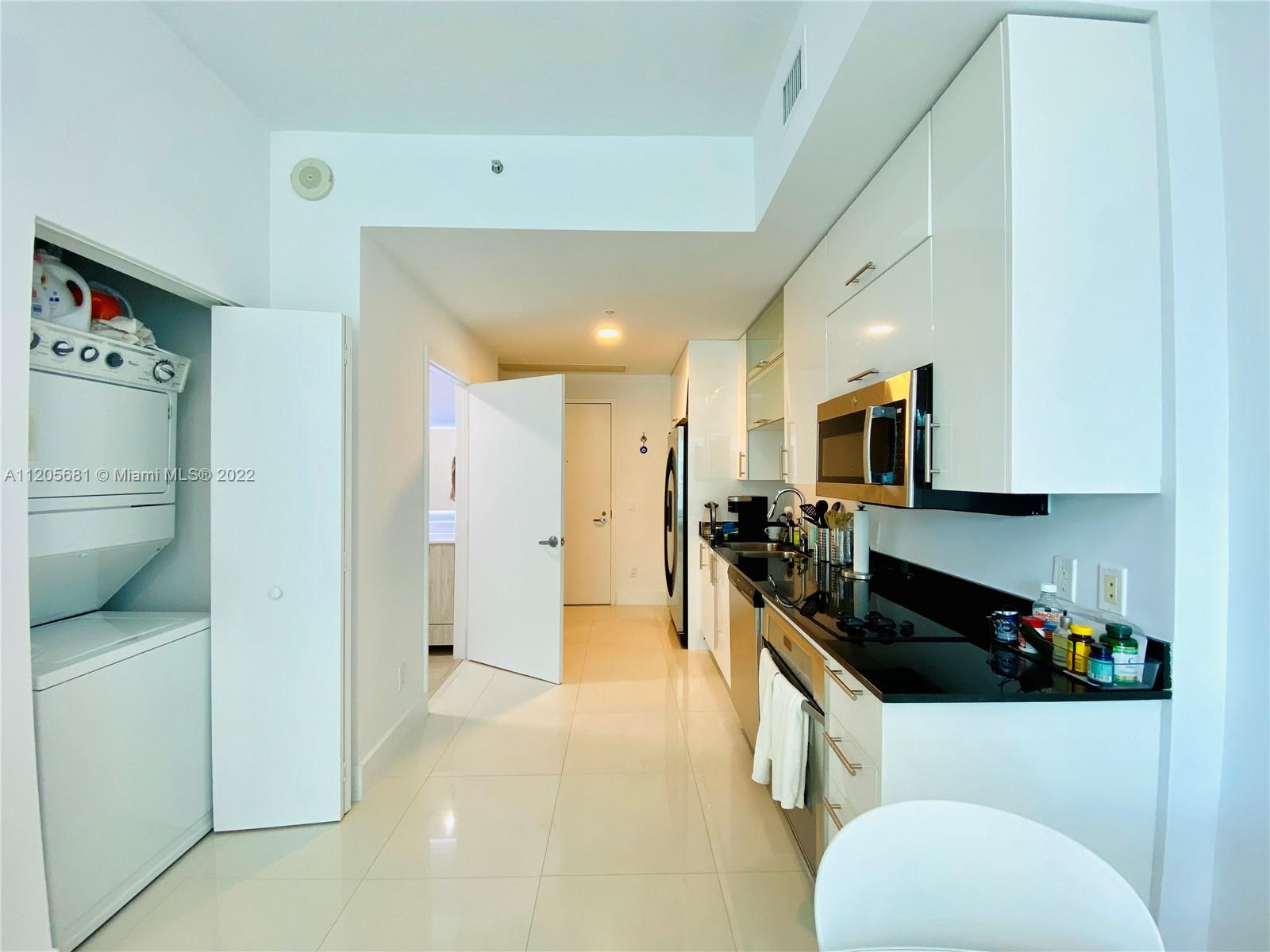 60 Southwest 13th Street, Unit 1412 Miami, FL 33130 - Photo 4 of 39 a kitchen with stainless steel appliances a refrigerator a sink a stove top oven a counter space and cabinets