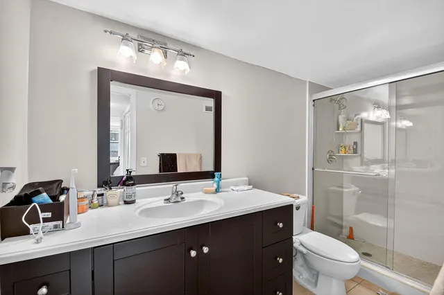 a kitchen with stainless steel appliances granite countertop a stove top oven a sink a dining table and chairs