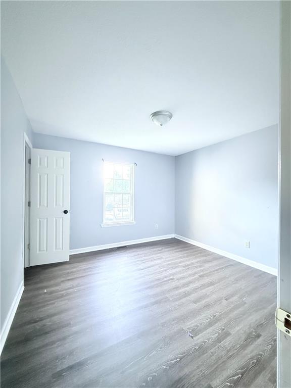 330 Peach Orchard Road Baldwin, GA 30531 - Photo 10 of 13 a view of an empty room with wooden floor and a window