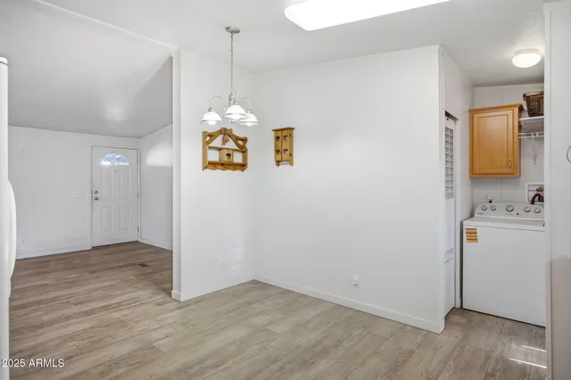a view of an entryway with wooden floor