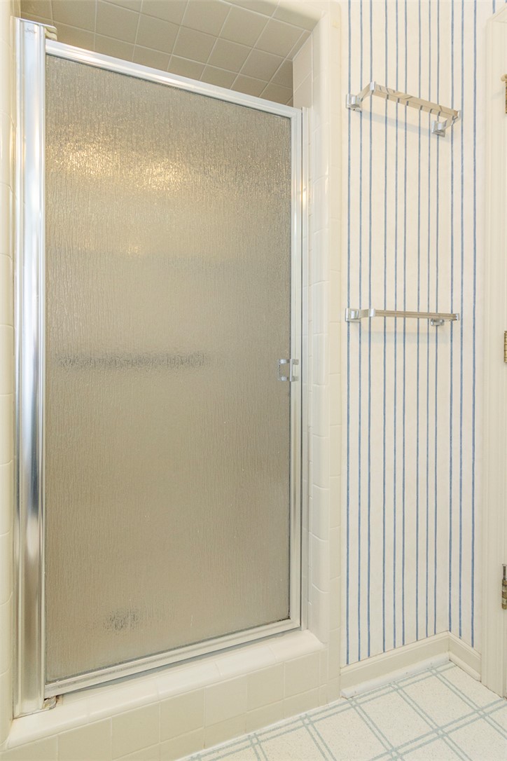 52 Hickory Way Clemson, SC 29631 - Photo 26 of 49 This bathroom features a shower with a frosted glass door and tiled walls.