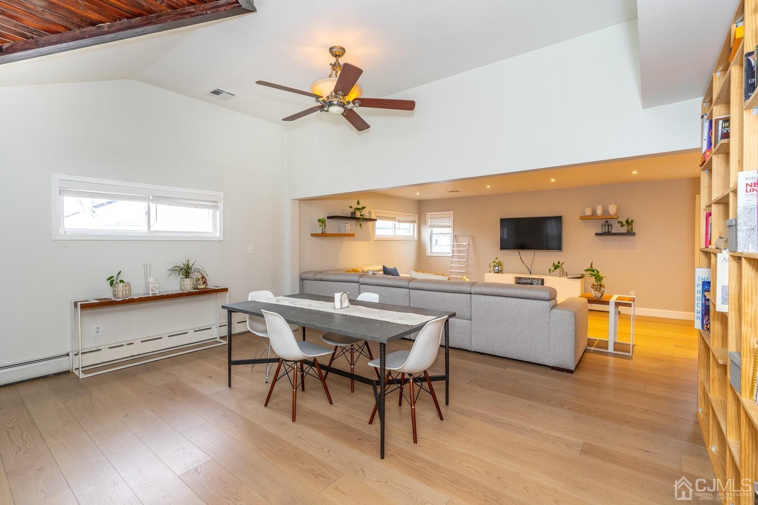 11 Baxter Road Edison, NJ 08817 - Photo 3 of 24 a kitchen with a table chairs and flat screen tv
