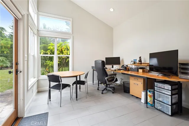 a view of a workspace with furniture and a window