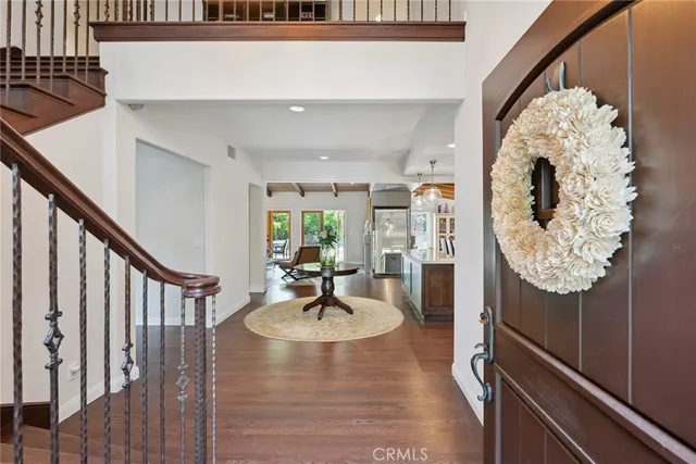 a view of entryway and hall with wooden floor