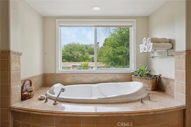 a bath tub sitting in a bathroom next to a window