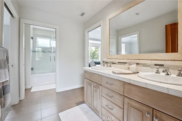 a spacious bathroom with a granite countertop sink mirror and shower