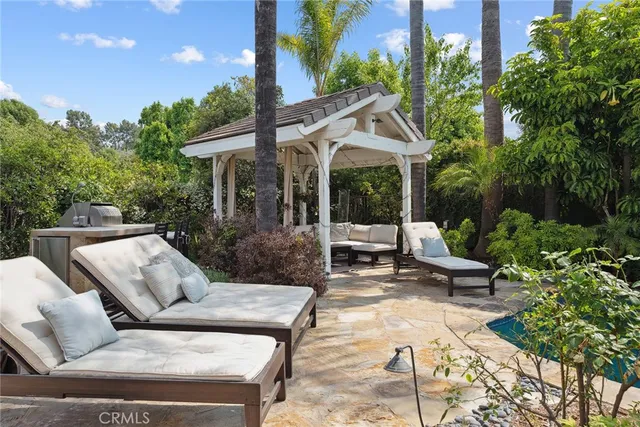 a view of a patio with couches table and chairs and potted plants