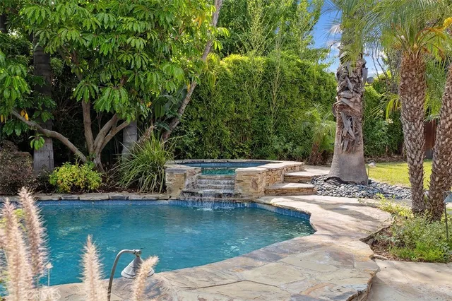 a view of a garden with lawn chairs
