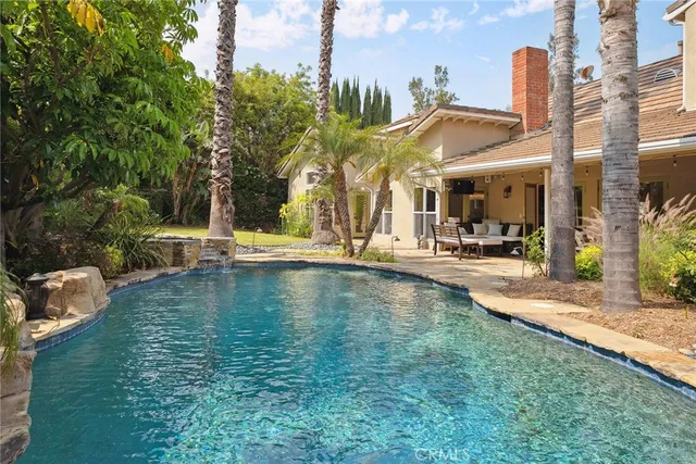 a view of a swimming pool with outdoor seating