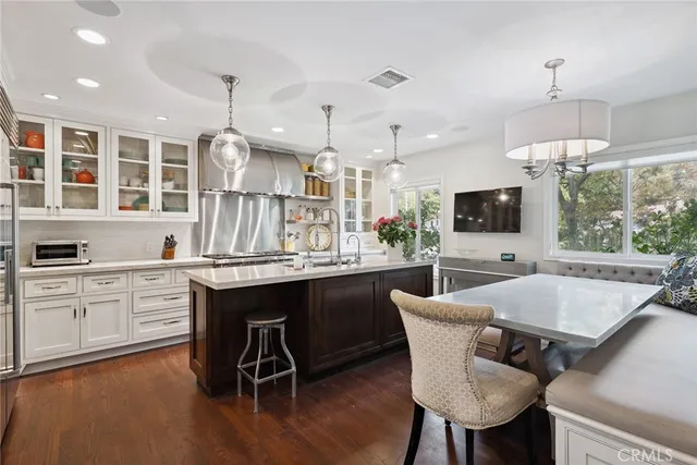 a kitchen with a table chairs sink and cabinets