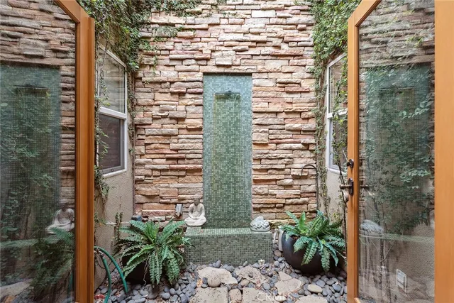 a view of a brick wall next to a building