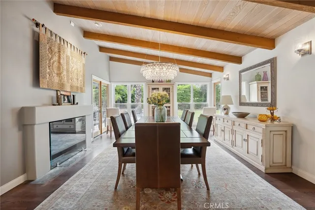 a dining room with furniture a chandelier and wooden floor