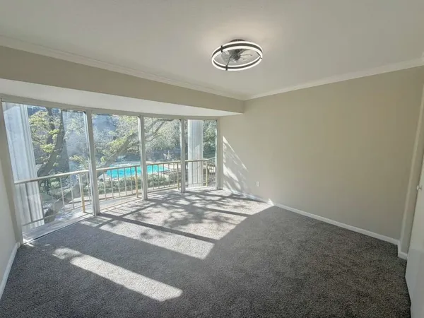 a view of a room with wooden floor and windows