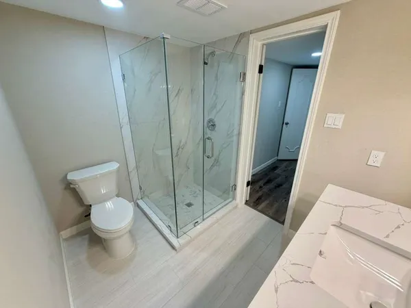 a bathroom with a toilet and a shower