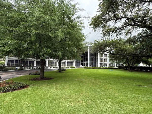 a kitchen with granite countertop a sink a stove top oven a refrigerator and blue cabinets