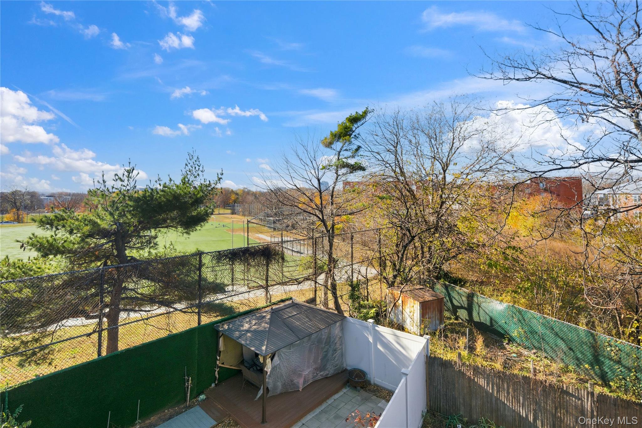 13716 88th Street Queens, NY 11417 - Photo 15 of 26 a view of a yard with plants and a bench