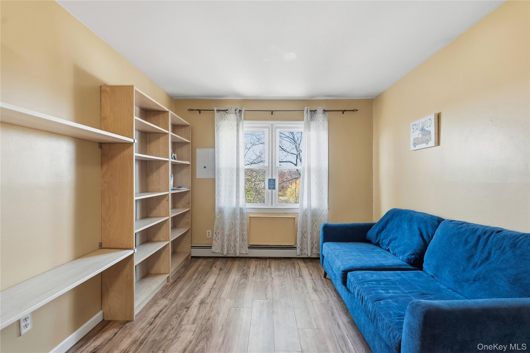 13716 88th Street Queens, NY 11417 - Photo 5 of 26 a living room with furniture and a window