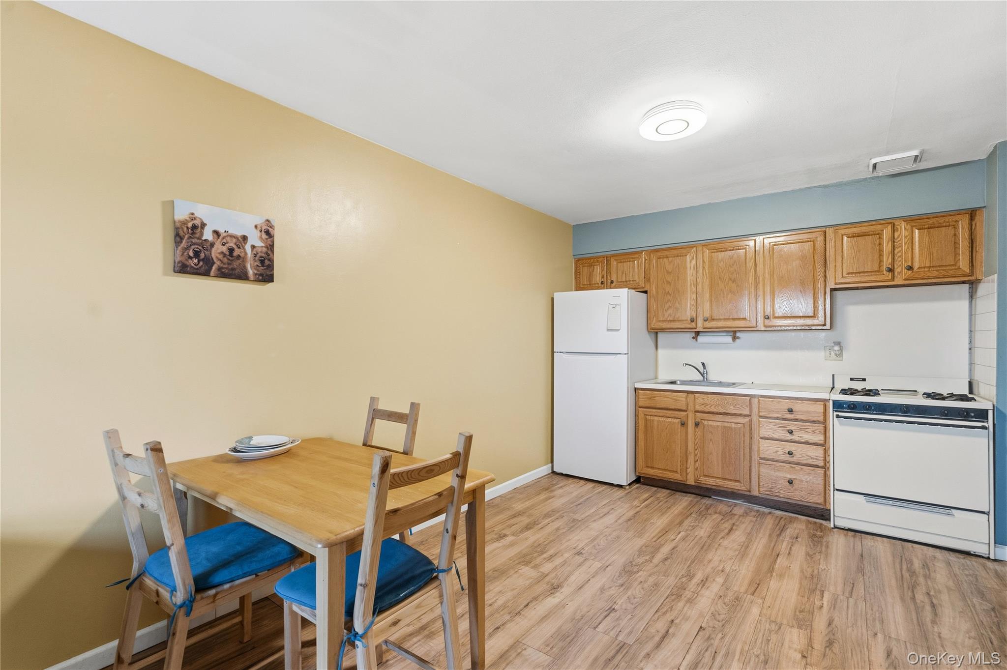 13716 88th Street Queens, NY 11417 - Photo 7 of 26 a kitchen with a table chairs refrigerator and cabinets
