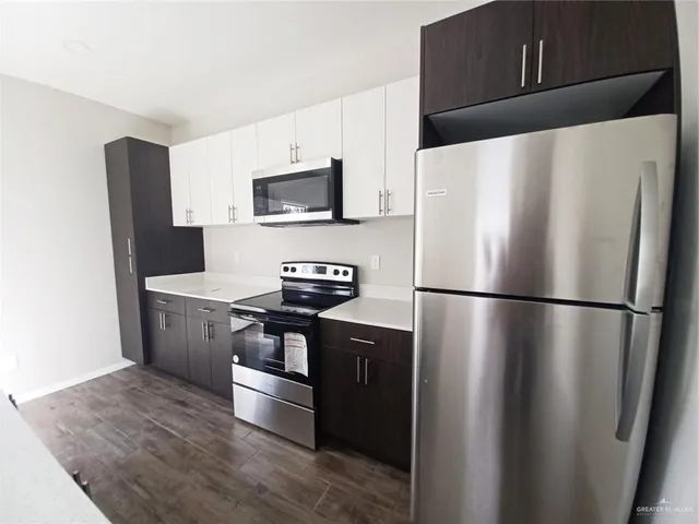 a white refrigerator freezer sitting in a kitchen