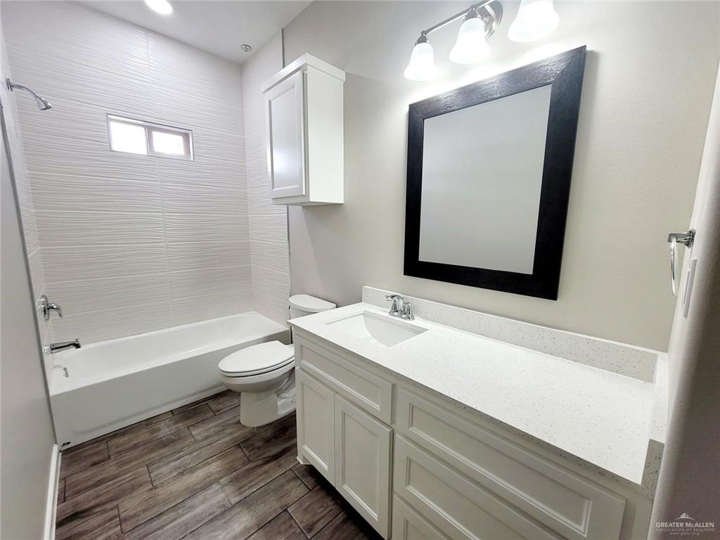 811 East Starr Road, Unit A Mercedes, TX 78570 - Photo 9 of 10 a bathroom with a toilet a sink and bathtub