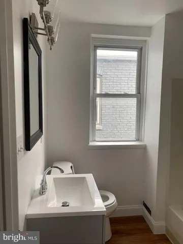 a bathroom with a sink and a window