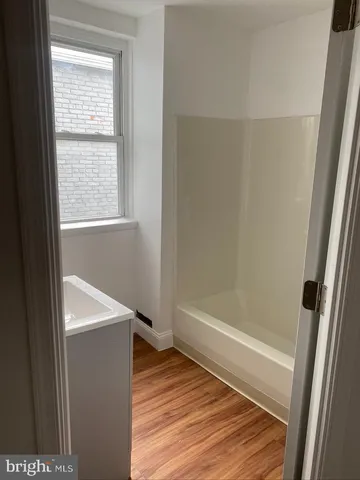 a bathroom with a tub and a shower