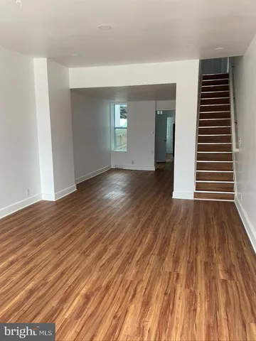 a view of a room with wooden floor and window