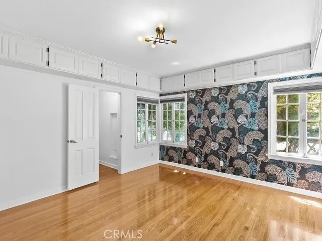 a view of a livingroom with wooden floor and a window