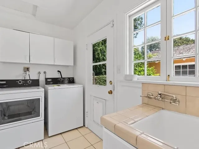 a utility room with cabinets dryer and washer