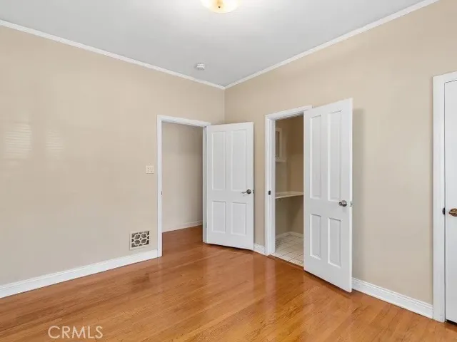 a view of an empty room with wooden floor