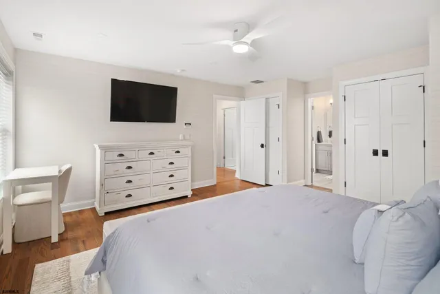 a bedroom with a bed and a television