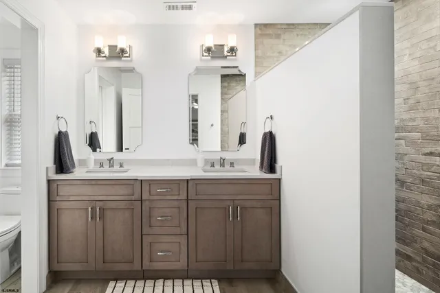 a bathroom with a double vanity sink and mirror