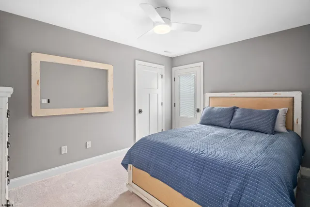 a bedroom with a large bed and a painting on the wall