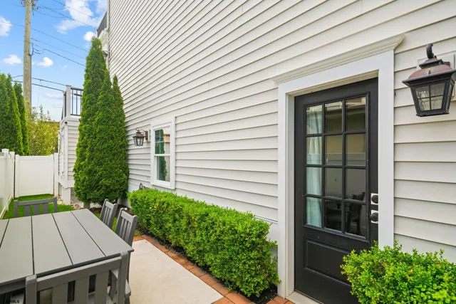 a view of house with backyard and sitting area