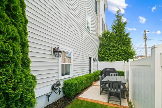 a view of a patio with table and chairs and potted plants