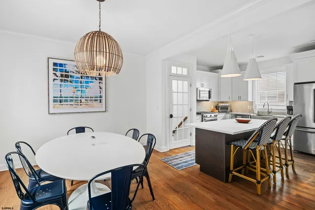 a view of a dining room with furniture wooden floor and chandelier