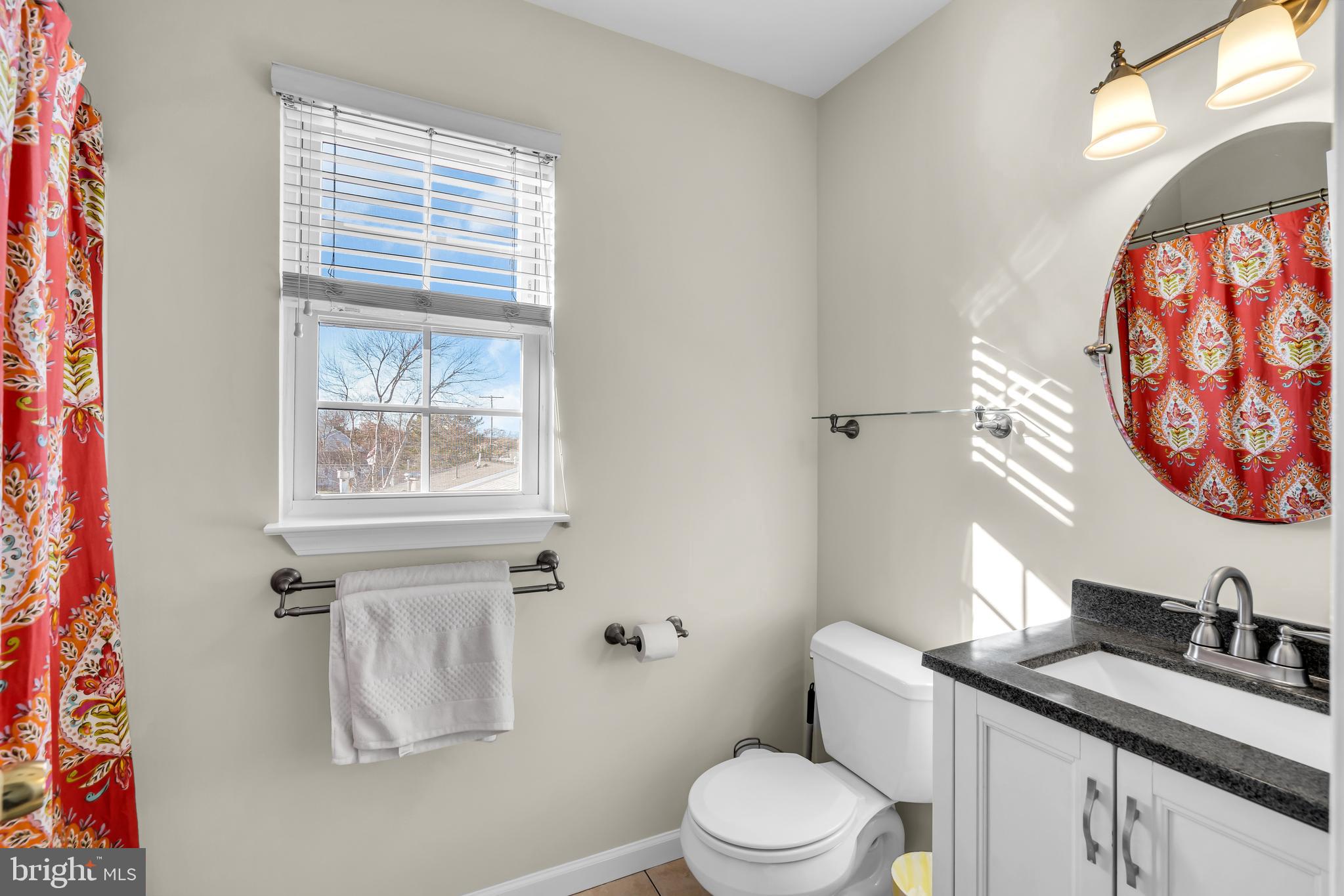 1007 Inland Road Forked River, NJ 08731 - Photo 13 of 27 a bathroom with a granite countertop sink mirror vanity and toilet