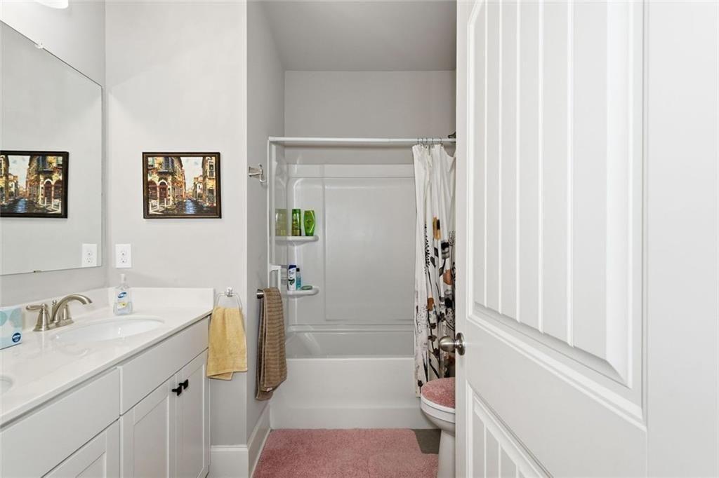 419 After Glow Summit Canton, GA 30114 - Photo 12 of 41 a bathroom with a sink a toilet and shower