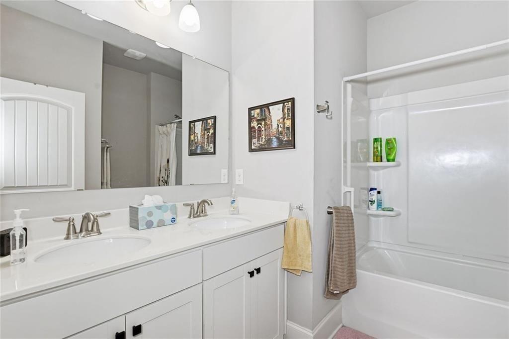 419 After Glow Summit Canton, GA 30114 - Photo 13 of 41 a bathroom with a sink double vanity and a tub