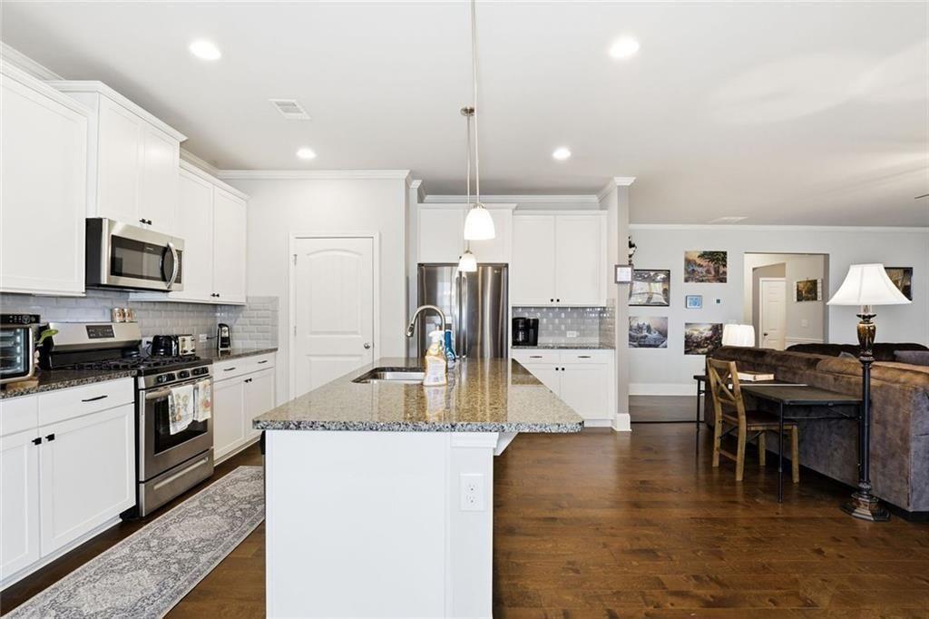 419 After Glow Summit Canton, GA 30114 - Photo 23 of 41 a kitchen with stainless steel appliances granite countertop sink stove refrigerator and cabinets